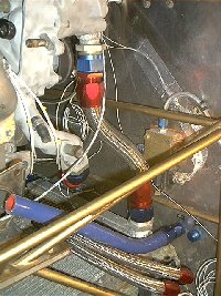 this is the short pipe from the water pump. The other one goes around the cool side of the engine to the other end of the rad